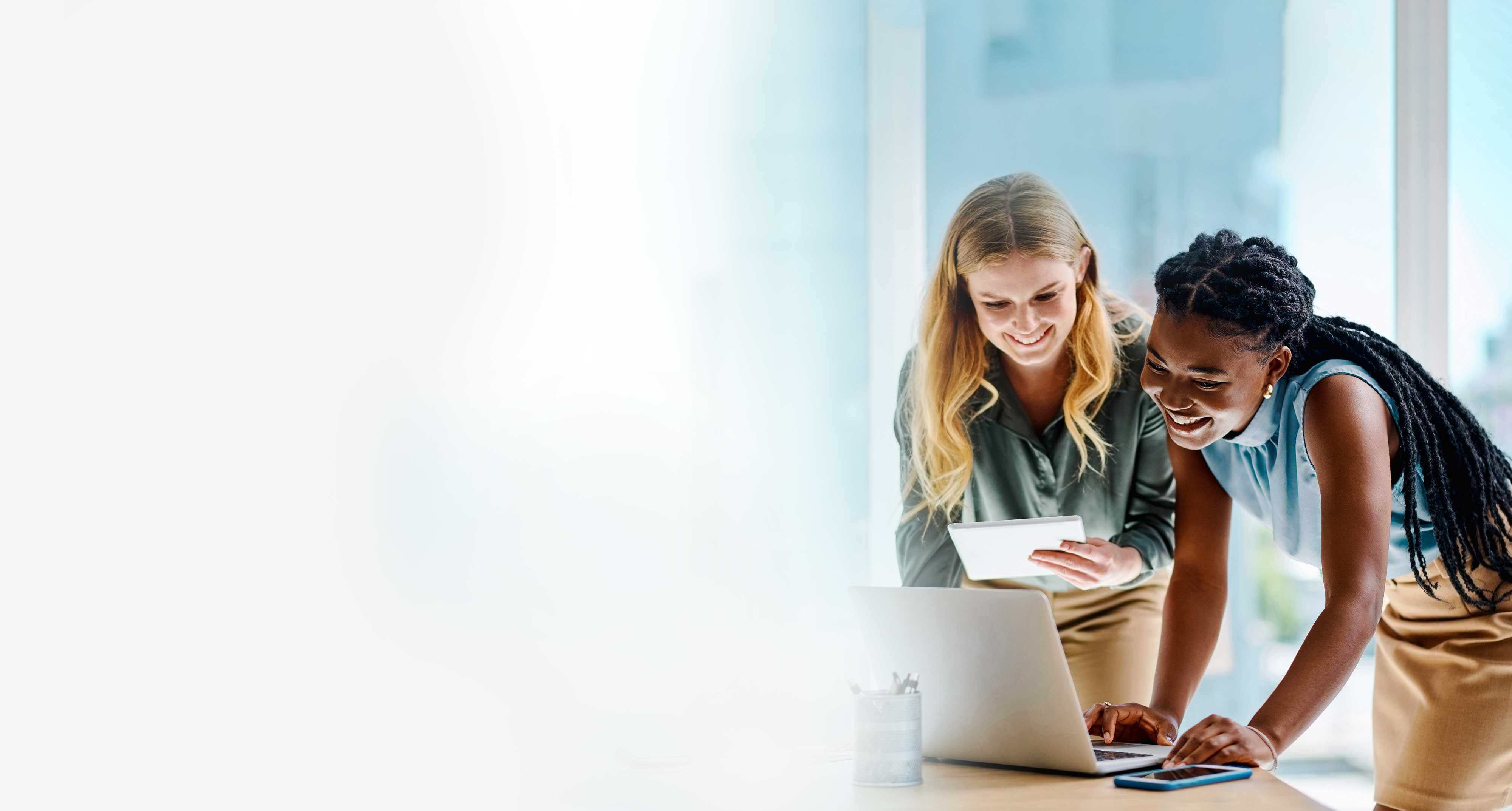 Two colleagues collaborating at a laptop